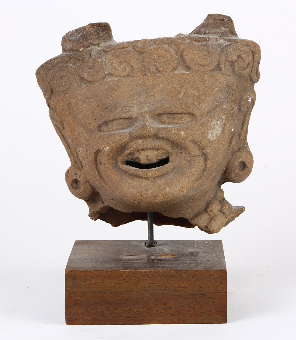 Pre-Columbian Veracruz ceramic head fragment of a lord or deity, the pronounced brow narrowing to an