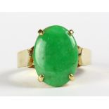 Jade and 14k yellow gold ring Featuring (1) oval jadeite cabochon, measuring approximately 15 X 10.9