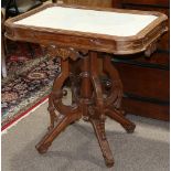 Victorian Eastlake walnut occasional table, circa 1880, having an inset marble top, above the carved