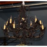 Normandie style wrought iron sixteen light chandelier, having scroll decorated supports continuing