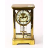 Ansonia brass mantle clock, the enameled dial with Arabic numerals and beveled glass to each side,