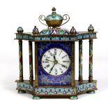 Champlevé style mantle clock, having an urn form finial, the case flanked by double columns, the