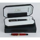 (lot of 2) Italian fountain pen group, consisting of an Omas titanium pen, having a black resin