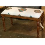 Primitive style bench, having a rectangular form, with brass nail head accents and rising on