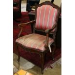 Louis XV walnut fauteuil second half 18th century, having a shaped back with a carved foliate crest,