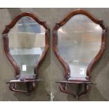 Pair of Regency mirrored wall brackets, circa 1820, the sculpted veneer frame above the shaped