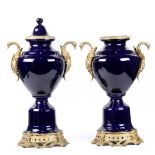 Pair of Sevres style porcelain mounted urns, executed in cobalt, having double metal mounted swan