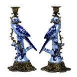 (lot of 2) Louis XV style patinated bronze candlesticks, each having a single light, above a figural