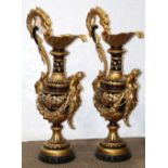 Pair of monumental Neoclassical style ewers, each having a dolphin form handle, above the