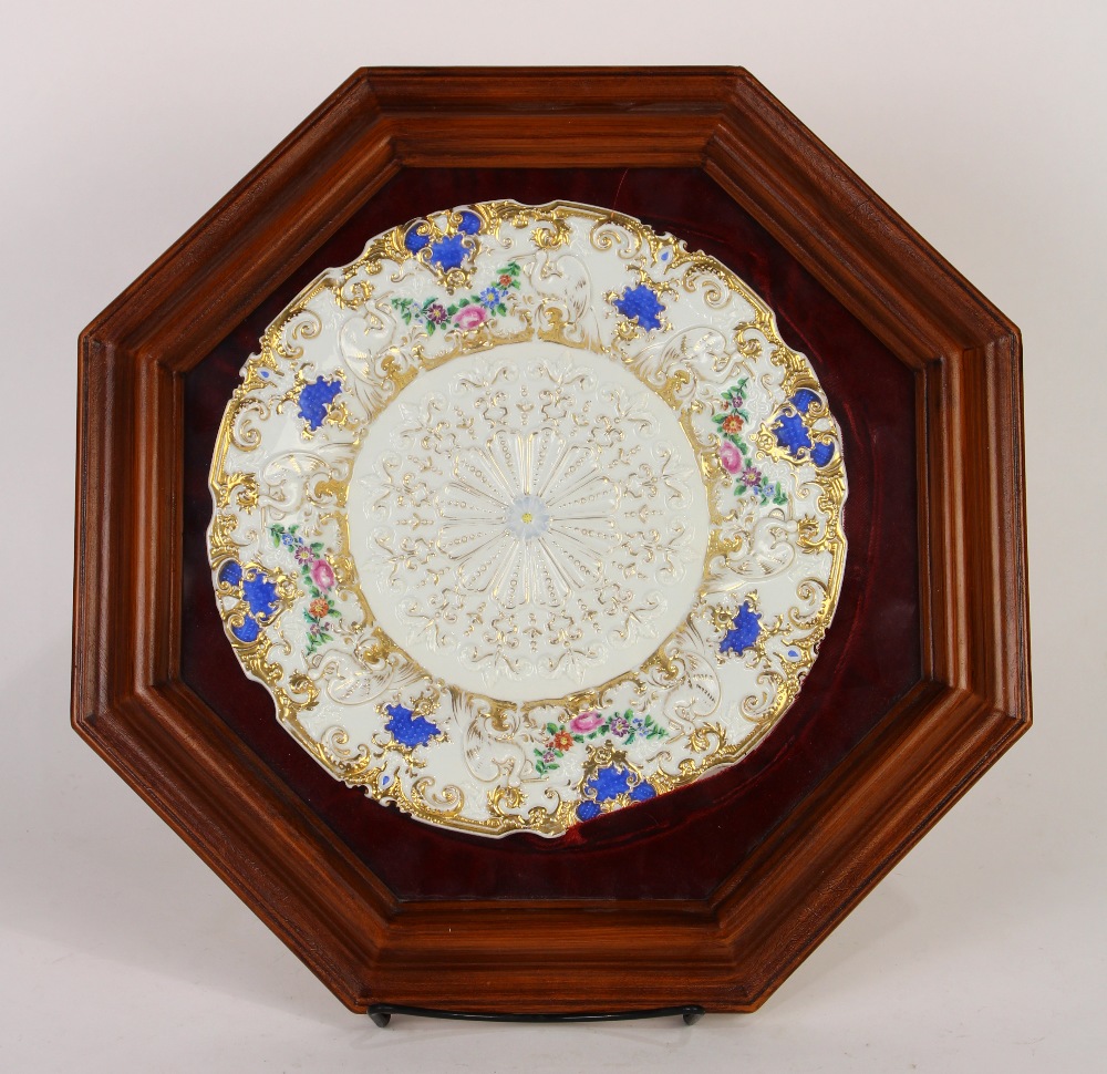 Framed Meissen porcelain plate, within an octagonal wood frame, the plate having a gilt shaped