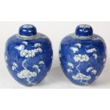 Pair of Chinese underglazed blue porcelain lidded jars, featuring prunus on a cracked-ice ground (
