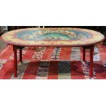 Decorated folk art table, having an oval form and polychrome and decorated with figures against a