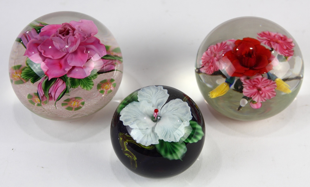 (lot of 3) Daniel Salazer for Lundberg Studios paperweight group, one decorated with a white lily,