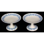 Pair of Wedgwood compotes, executed in the "Embossed Queensware" style, having a white ground with