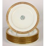 (lot of 8) Minton porcelain service plates, the gilt double banded border having daises within