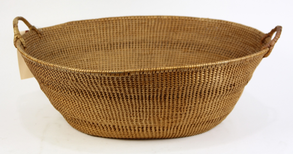 Woven basket, having a splayed rim and double handles, 8.5"h x 27"w x 22"d