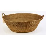 Woven basket, having a splayed rim and double handles, 8.5"h x 27"w x 22"d