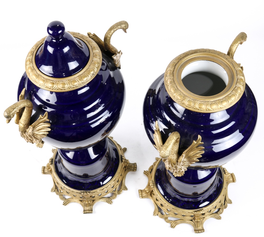 Pair of Sevres style porcelain mounted urns, executed in cobalt, having double metal mounted swan - Image 3 of 3