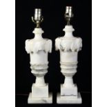 Pair of continental carved carerra marble lamps, each of urn form and rising on a graduated base,