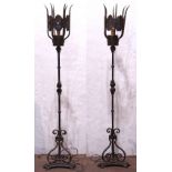 Pair of Spanish Revival wrought iron torchieres, each having a single light with a pierced shade,