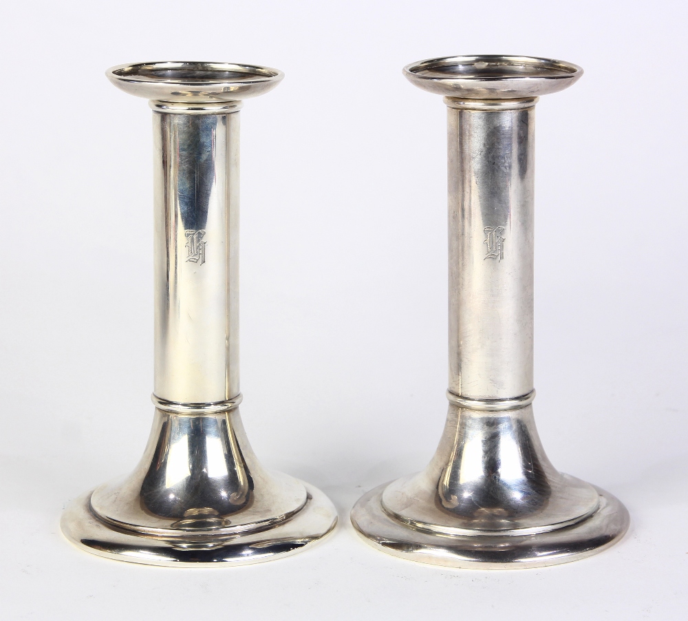 Pair of Tiffany & Co. sterling silver weighted candlesticks, each columnar standard rising on a