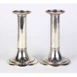 Pair of Tiffany & Co. sterling silver weighted candlesticks, each columnar standard rising on a
