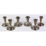 (lot of 6) Three pairs of American sterling silver weighted candlesticks, each associated single-