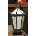 Spanish Revival style slag glass lantern, having a turned finial, above the paneled sides executed