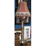 Egyptian Revival style multi-metal table lamp, the tasseled shade rising on an ornately decorated