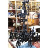 Murano black glass chandelier, having a baluster support continuing to fourteen lights, each