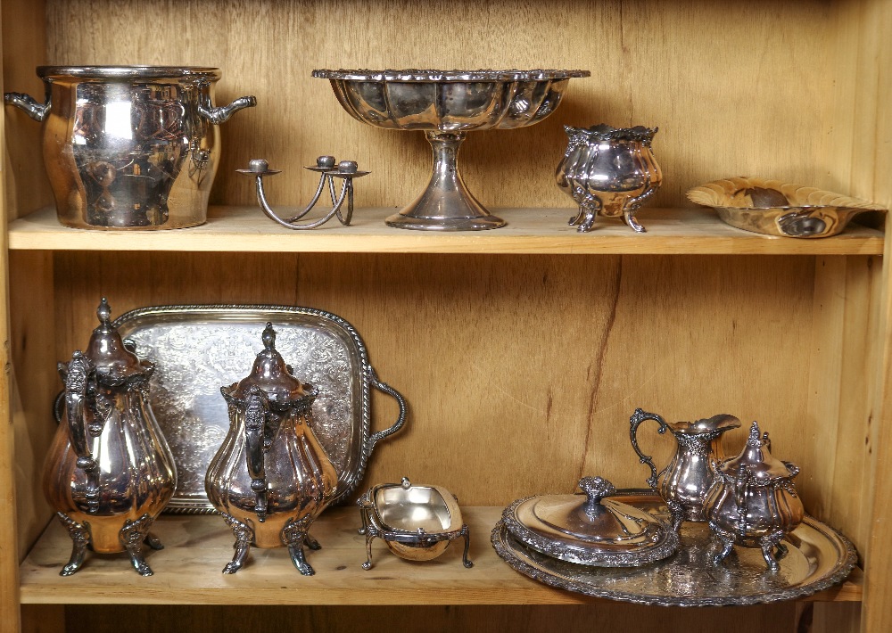 Two shelves of silver plate table articles including a lidded tureen, a footed compote, a serving