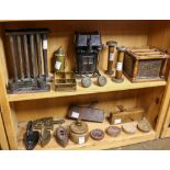 (lot of 21) Two shelves of primitive tools, including a candle mold, cast iron irons, wood butter