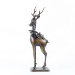 Copper alloy sculpture of a deer, in formal stance with a peach sprig in its mouth, the lid