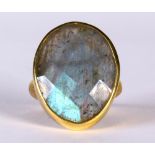 Labradorite and silver-gilt ring Featuring (1) oval shaped faceted top labradorite cabochon,