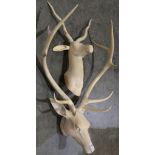 (lot of 2) Carved figural sculptures, one depicting a deer trophy, one depicting an antelope,
