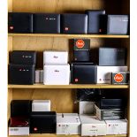 Three shelves of Leica boxes and cases, including plastic boxes with fitted interiors and well as