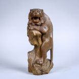 Japanese wooden sculpture of a yamaneko cat, leaning on the tree stump with jaw open, signed