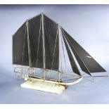 Mid century modern brass sail boat sculpture, the sails executed in smoked gray plastic, rising on a