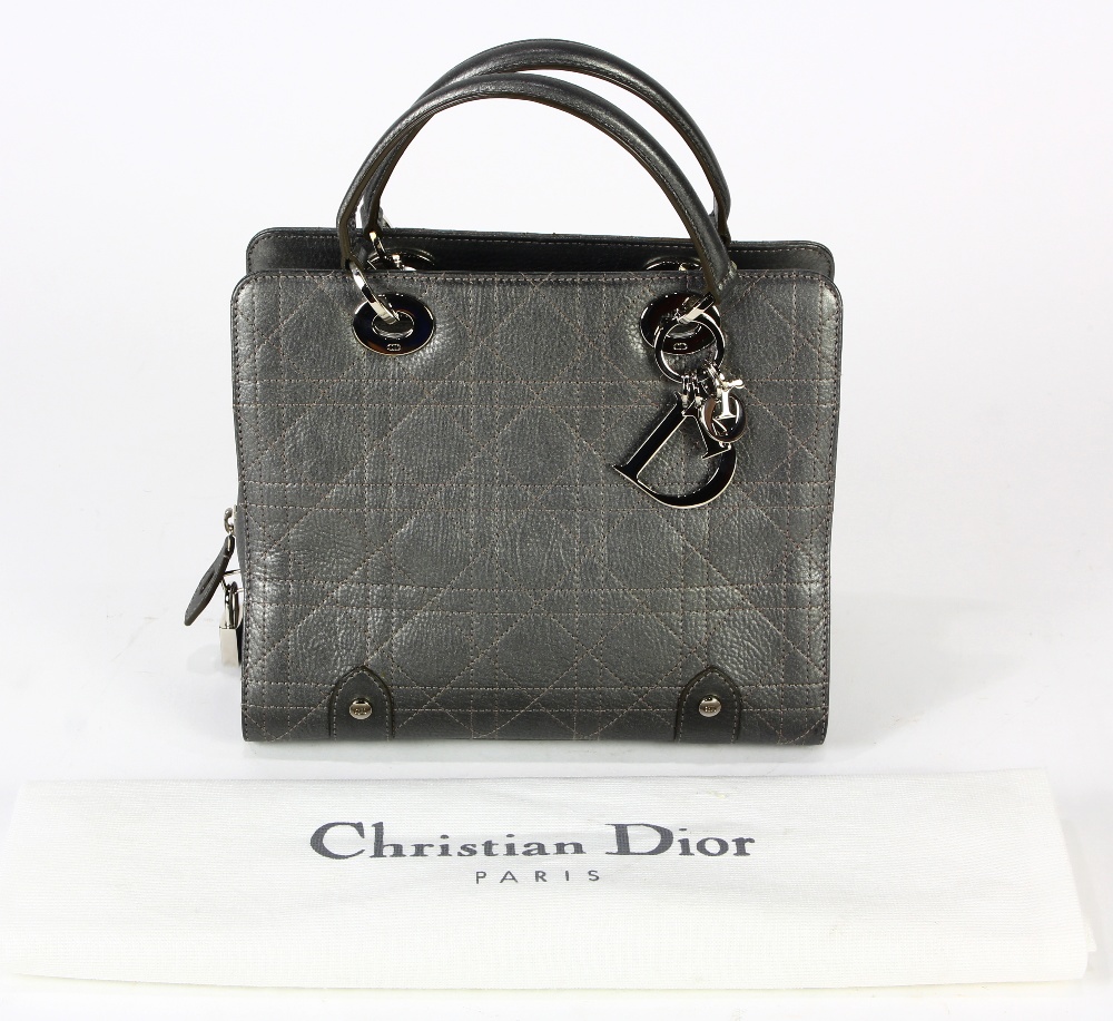 Christian Dior textured lady's handbag, executed in pewter, the hardware labeled "CD", with dust