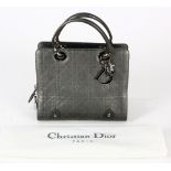 Christian Dior textured lady's handbag, executed in pewter, the hardware labeled "CD", with dust