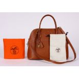 Hermes veau doblis bolide handbag, executed in tan, 31cm, with strap, lock, clochette, dust bag,