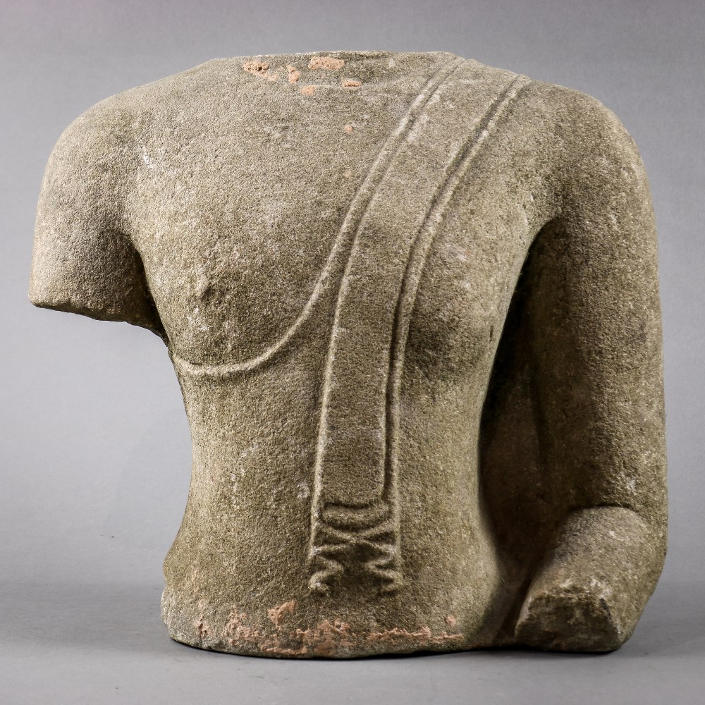 Thai sandstone torso, adorned in a simple monk's robe with fabric draping down the left shoulder,