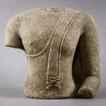 Thai sandstone torso, adorned in a simple monk's robe with fabric draping down the left shoulder,