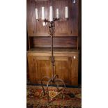 Spanish Revival wrought iron candlestand, having five arms above the twist form standard rising on a