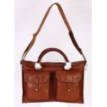 Ghurka leather travel bag, executed in brown, having a double handle with attached leather strap,