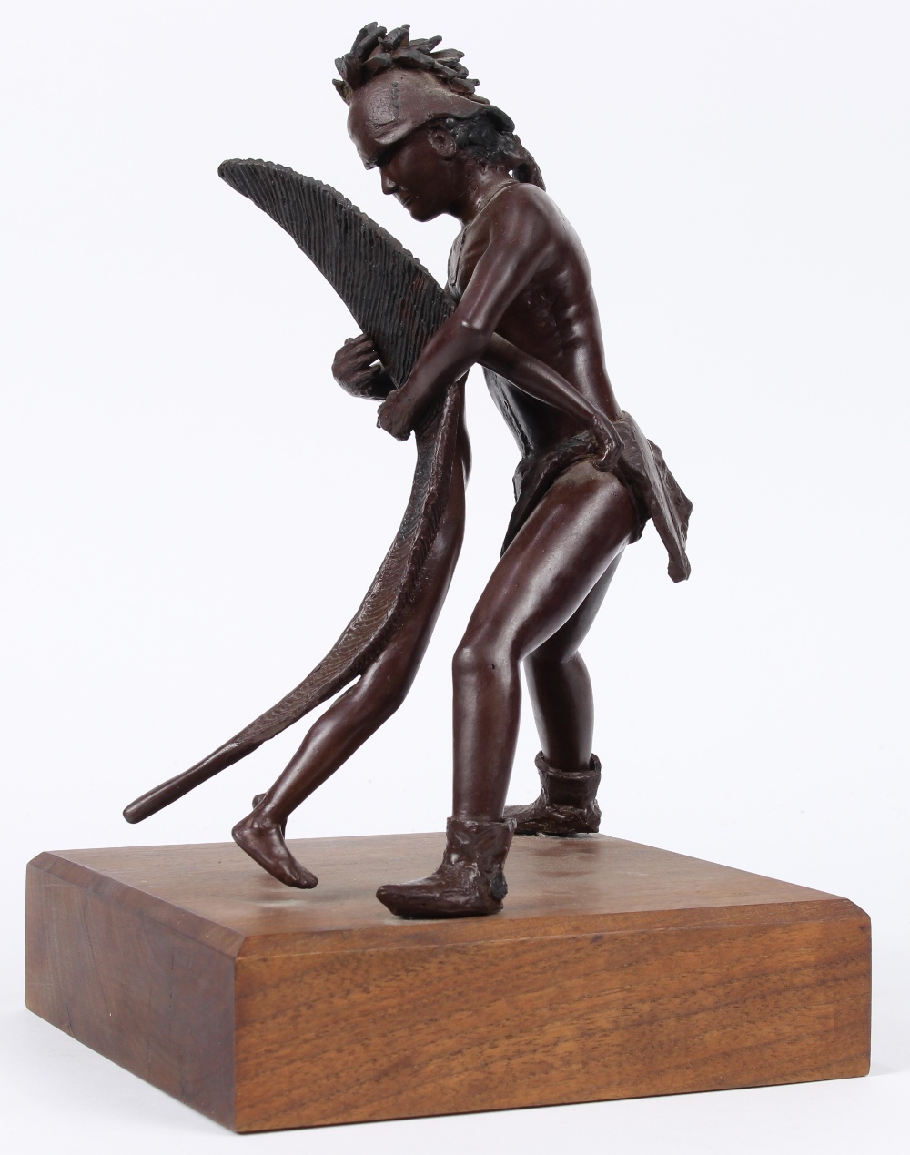 Patinated bronze Native American figure, modeled as embracing a feather girl, rising on a wood base,