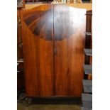 Art Deco style armoire the two door case with an inset veneered fan motif, rising on cabriole