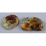(lot of 2) Chinese hardstone belt buckles, the first carved with a chilong in relief; the second, of