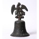 Antique cast iron bell, the whole surmounted by a phoenix with outstretched wings, 8"h x 5.5"dia.