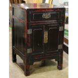 Chinese lacquered wood small cabinet, with a shallow drawer above hinged double doors, with brass